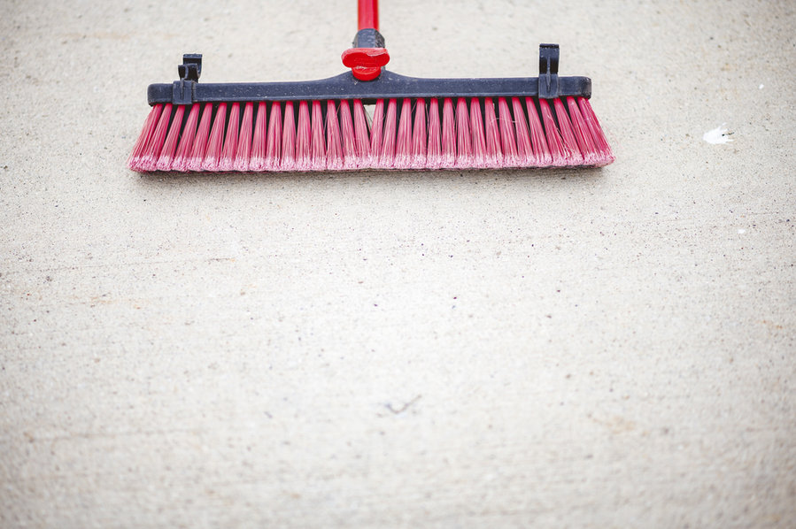 A Top View Of A Red Broom Brush Head On A Concrete Ground