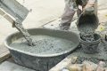Builders Pouring Ready-Mixed Concrete