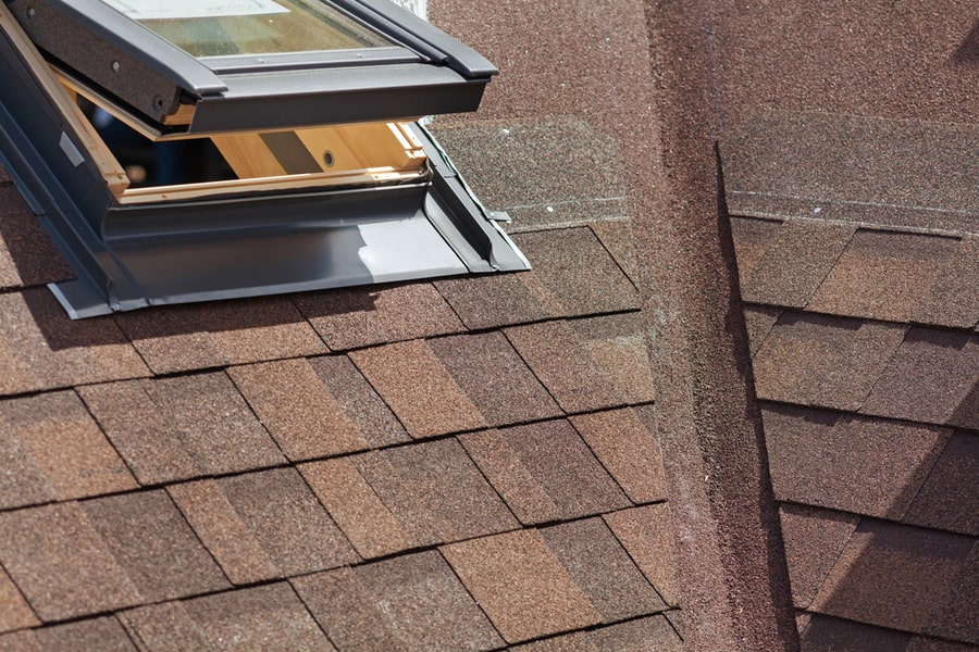 Closeup Of Window Skylight On A Roof With Asphalt Shingles Or Bitumen Tiles Under Construction