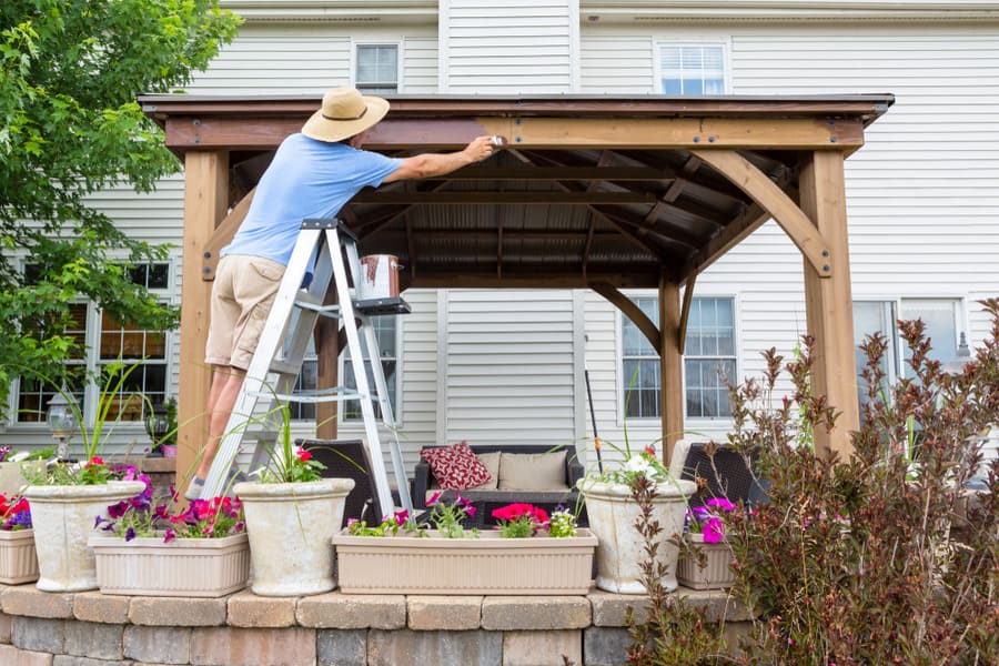 Homeowner Staining A New Wood Gazebo