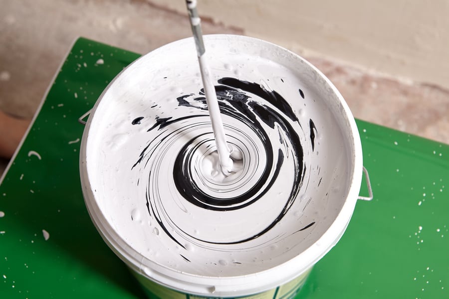 House Painter Mixes Two Paints Using Mixer For Bucket With Paddle Mixing Tool