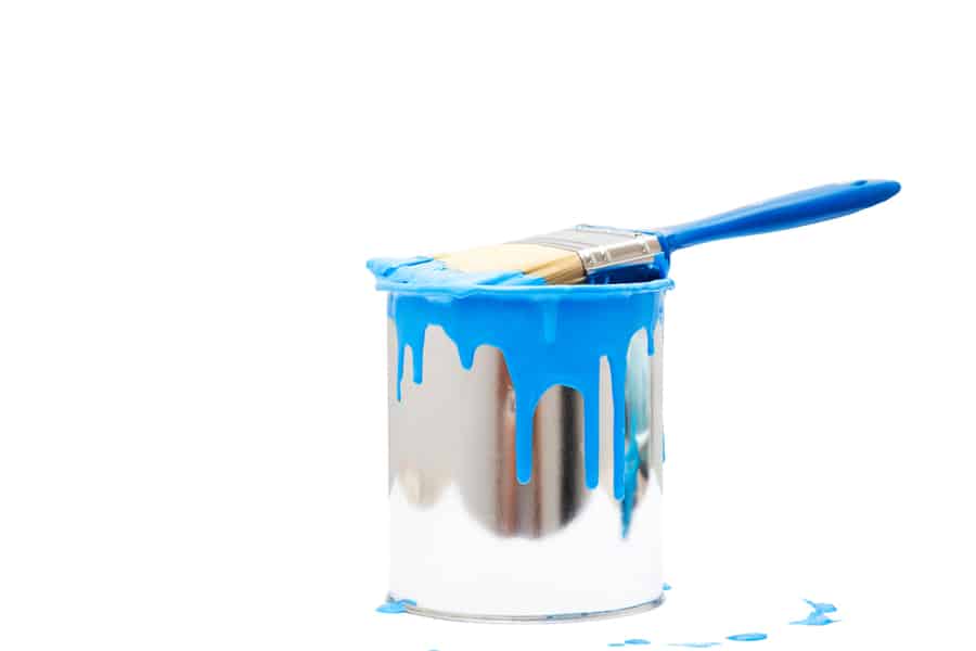 Painted Bucket And Paintbrush On A White Backdrop