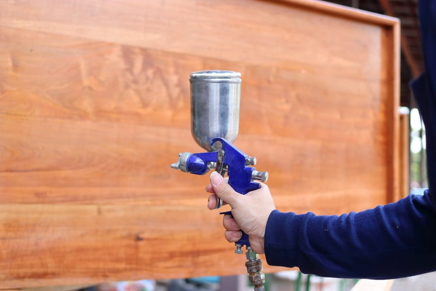 Applying Spray Paint Gun On Plywood
