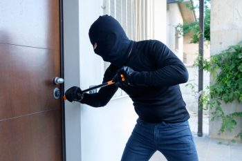 Burglar Trying To Force A Door Lock