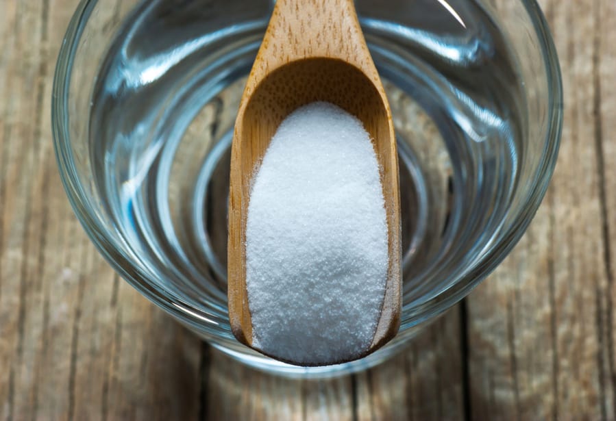 Carbonate Powder Or Baking Soda And Glass Of Water On Wooden Table