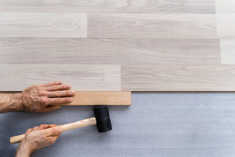 Carpenter Laying Laminate Flooring