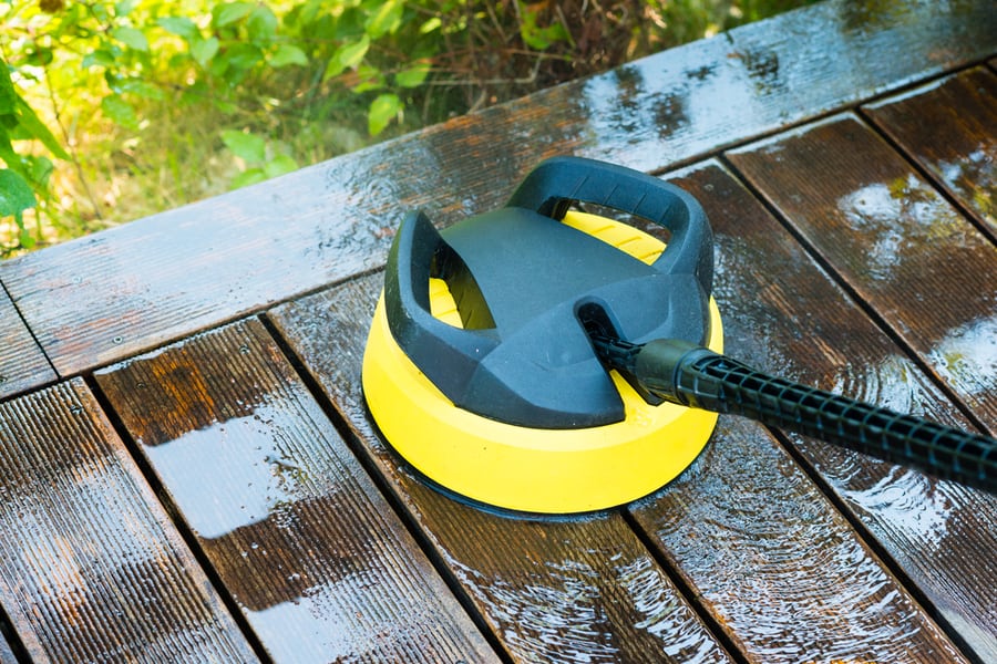 Cleaning Terrace With A Power Washer - High Water Pressure Cleaner On Wooden Terrace Surface