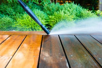 Cleaning Terrace With A Power Washer - High Water Pressure Cleaner On Wooden Terrace Surface