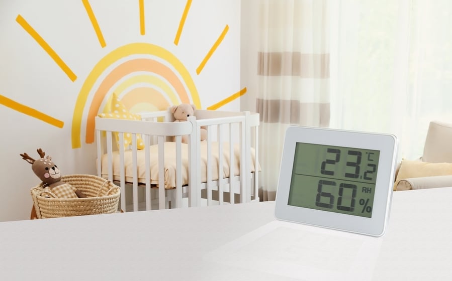 Digital Hygrometer With Thermometer On White Table In Children's Room