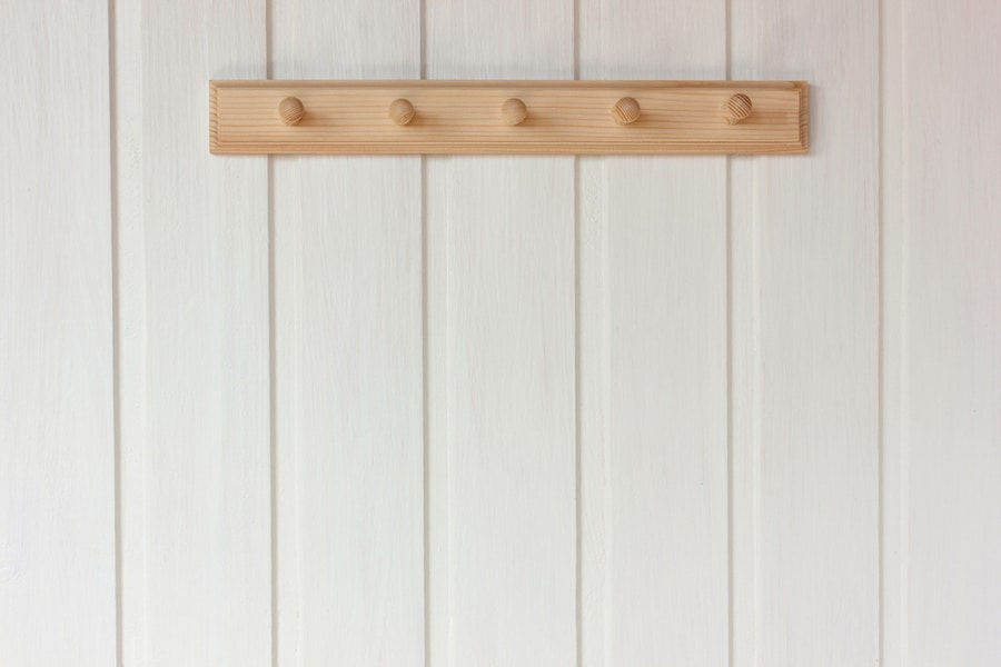 Natural Wooden Empty Hanger On A White Wall. Rustic Interior As Background, Copy Space.