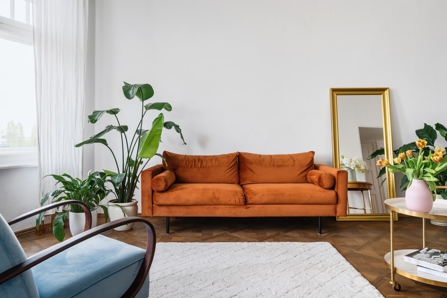 Old Fashioned Furniture In Lounge With Armchair And Sofa Against White Wall