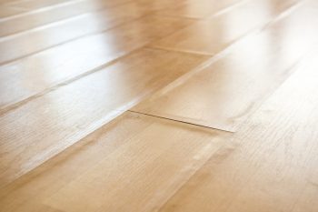 Swollen Laminate Flooring From Flood Or Water Damage, Perspective View.