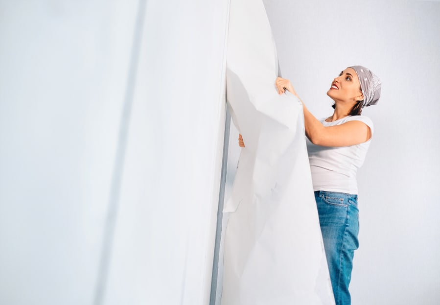 Woman Prepare Room For Renovation, Take Off Wallpapers From Wall