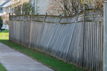 Damanged And Leaning Fence Post