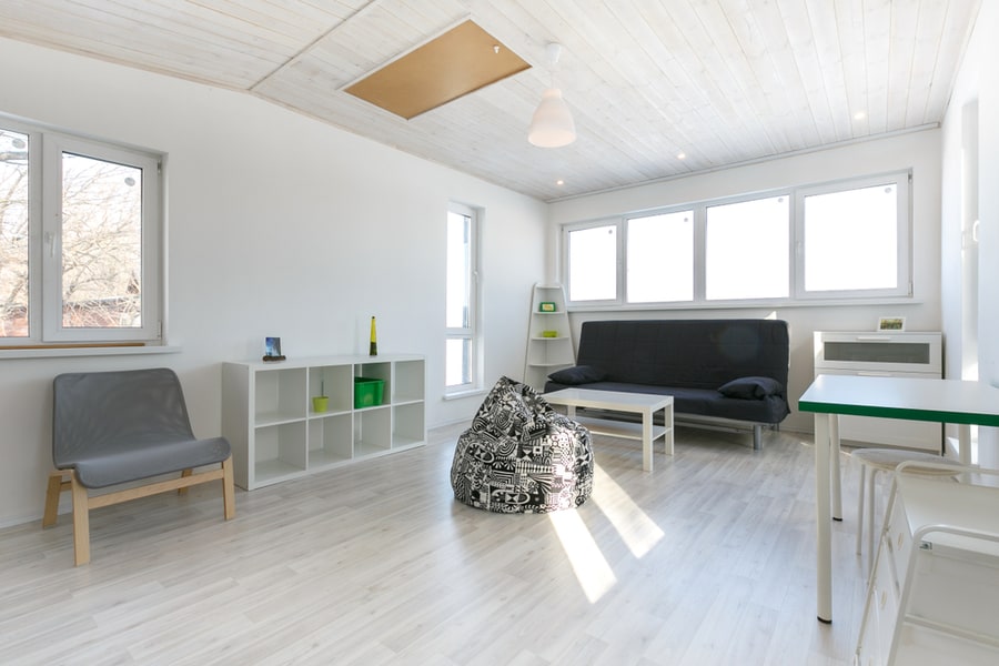 Minimalistic Living Room Interior, Photo In Cottage With Wooden White Celling, White Painted Walls, Laminate Floor