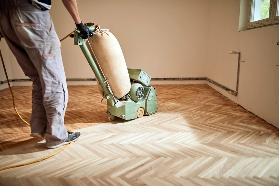 Repairman Restoring Parquet With A Sanding Machine.