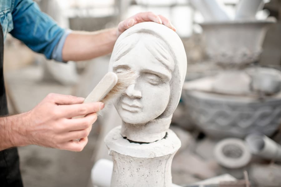 Sculpture Of The Female Head Cleaning With Brush In The Old Studio