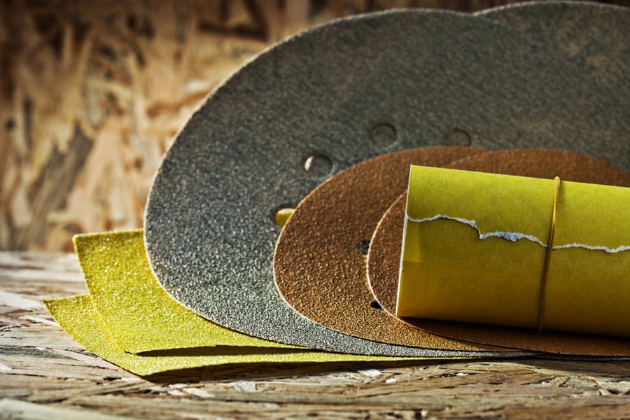 Abrasives Round Square And Rolled Sheets Of Sandpaper On Plywood Background