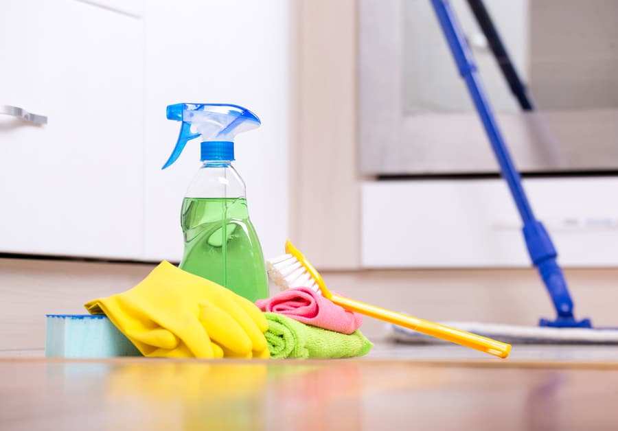 Cleaning Supplies And Equipment On Kitchen Floor