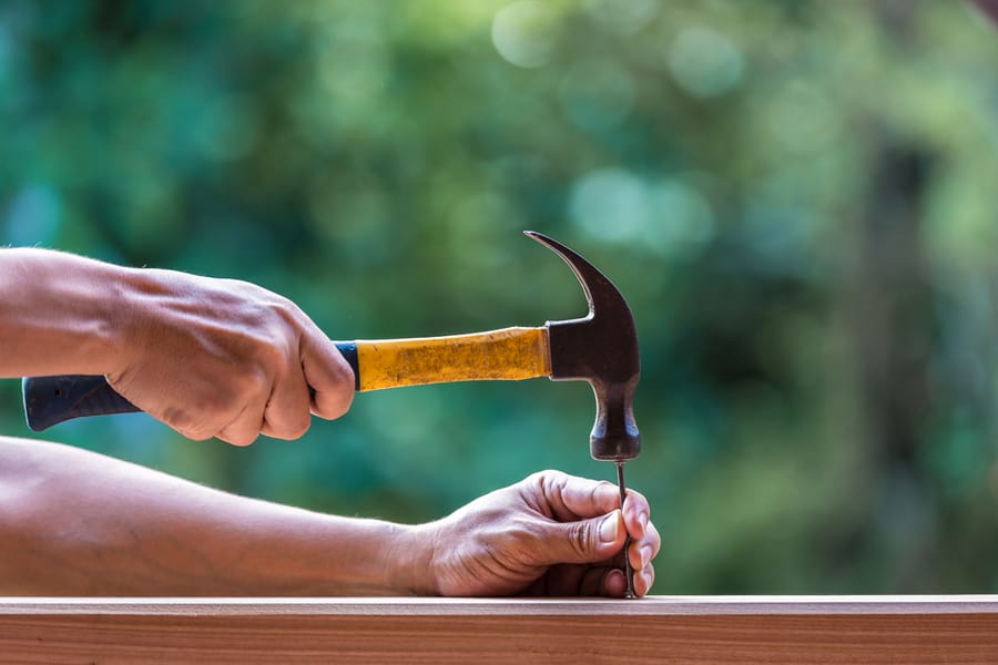 Hammer And Nail On Wood