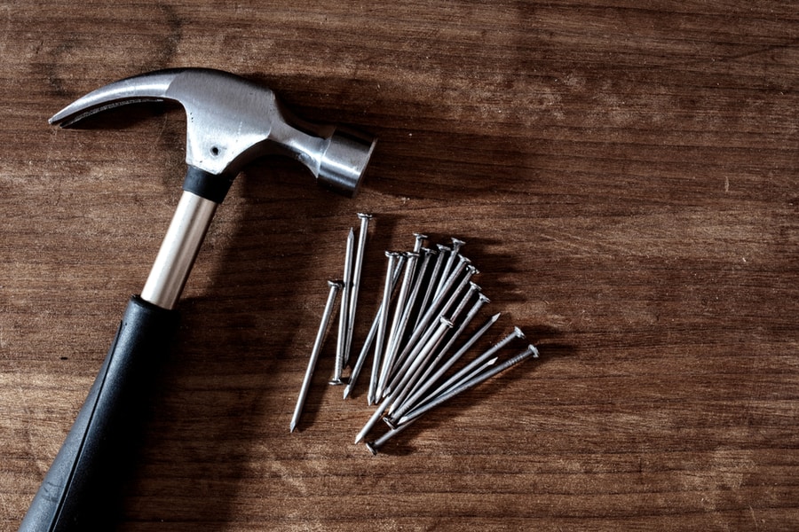 Hammer And Nails On Wooden Background