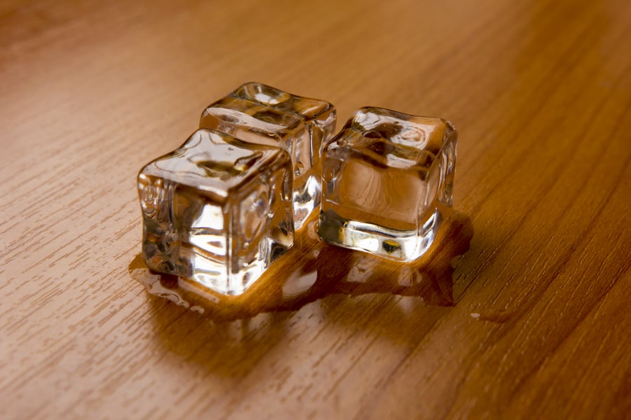 Ice Cubes On Wooden Floor