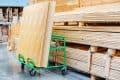 Large Sheets Of Plywood Lie On A Transport Cart In A Building Supplies Store.