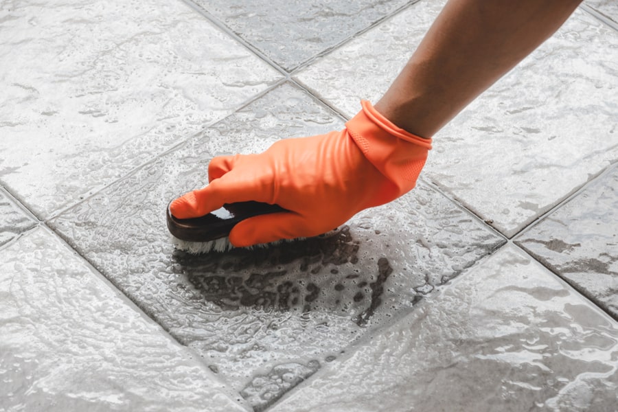 Man Wearing Orange Rubber Gloves Cleaning Floor