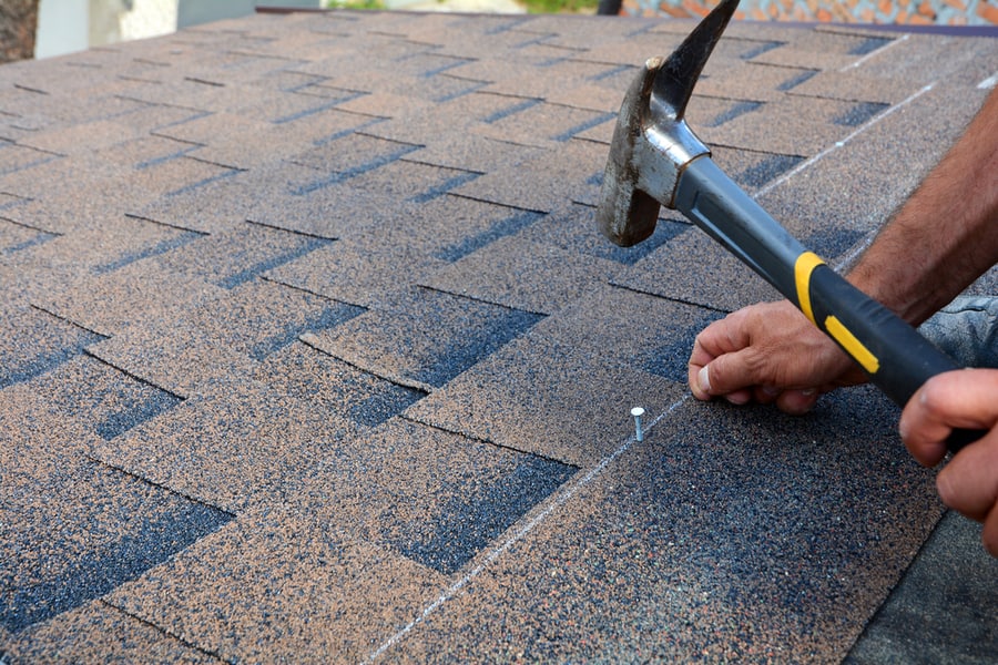 Roof Shingles With Hammer And Nails