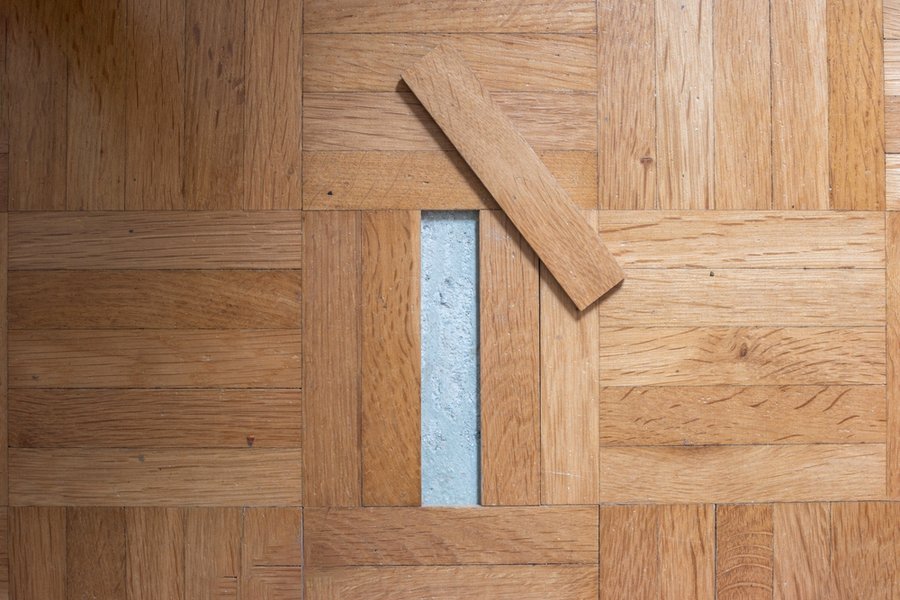 Unglued Or Unstuck Wooden Tile From An Old Apartment Parquet Floor.