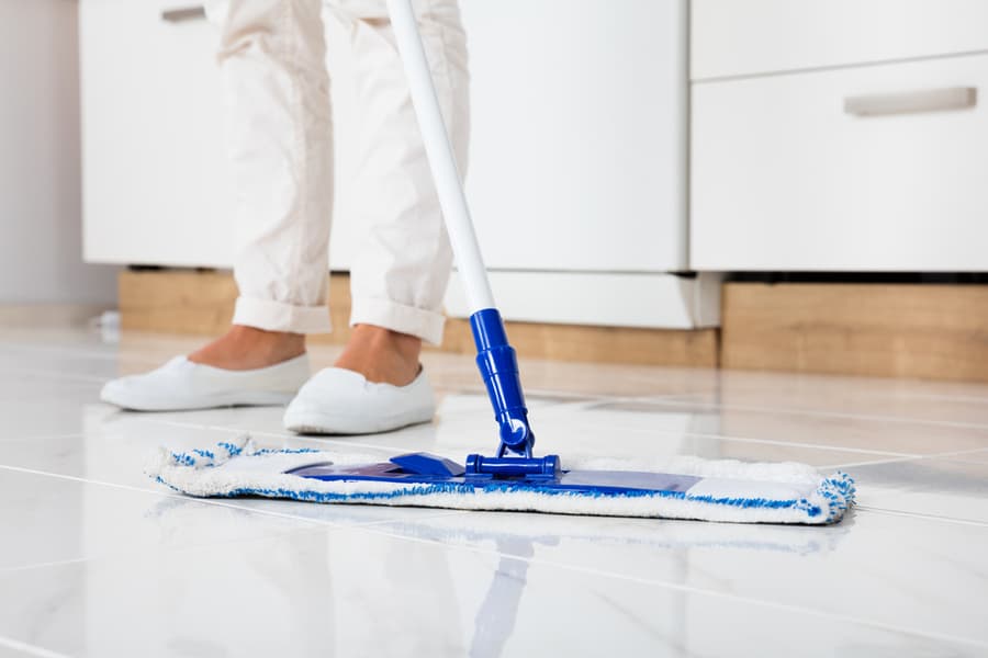 Woman Mopping The Tile Floor