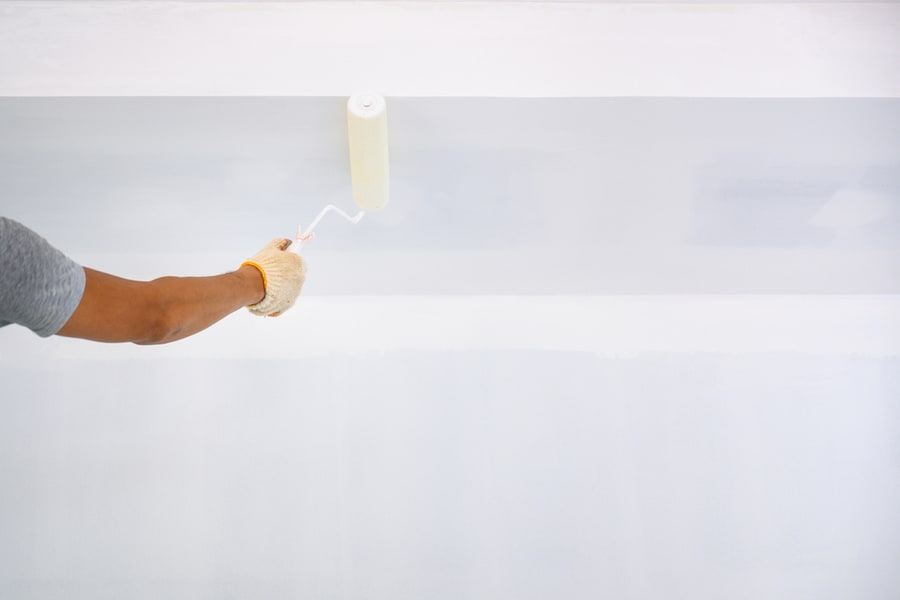 Workers Use A White Primer Paint Roller