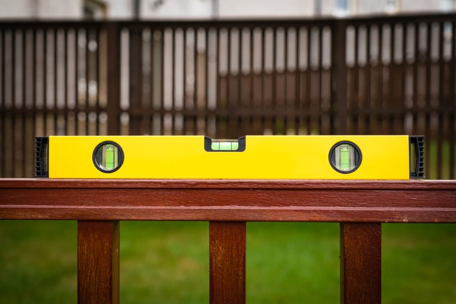Yellow And Black Spirit Level On A Wooden Rail